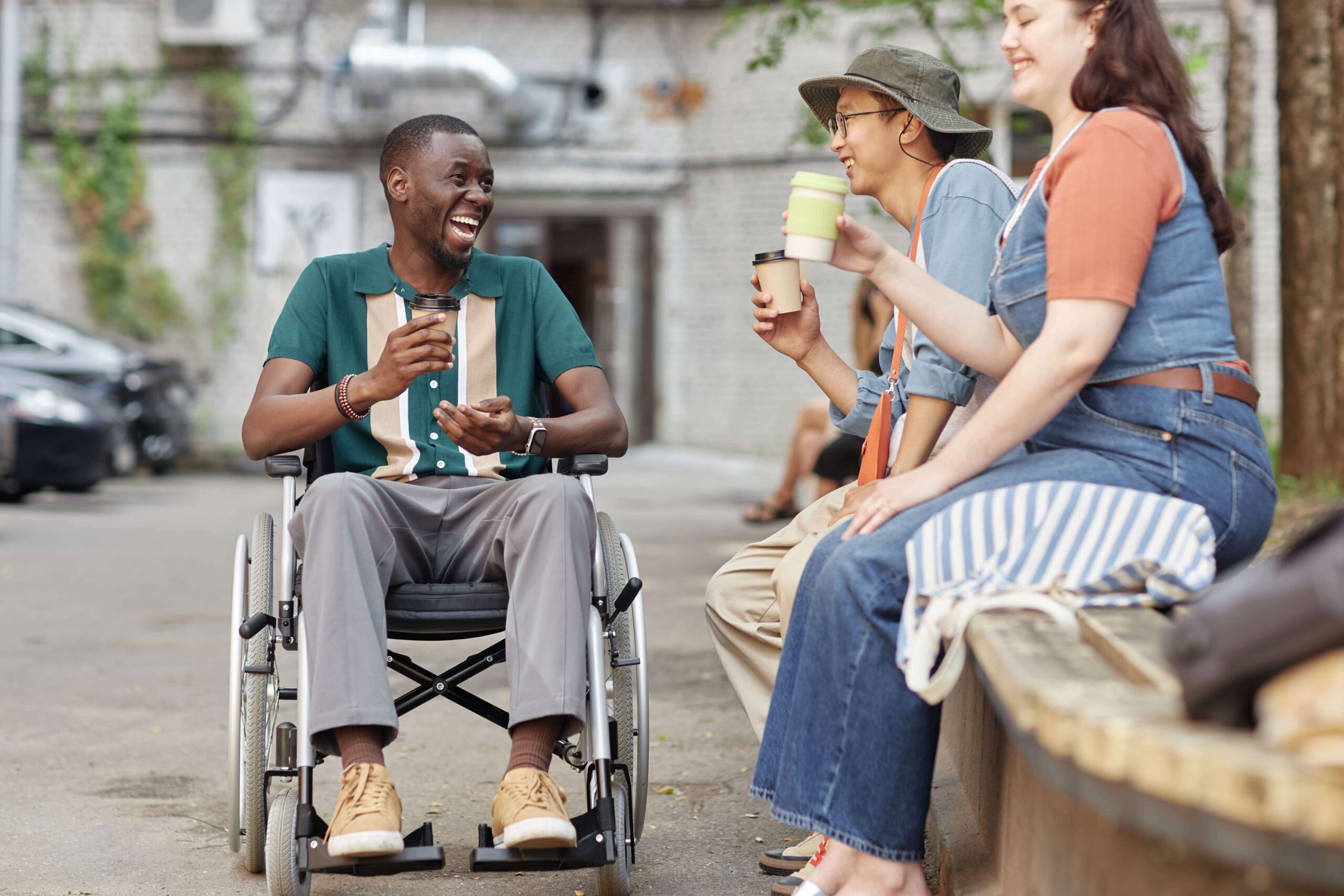 man with disability chatting while doing community participation and daily tasks shared living