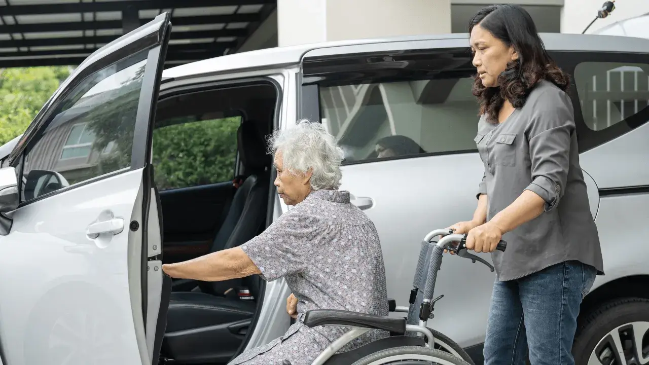 elderly disabled woman getting in a car